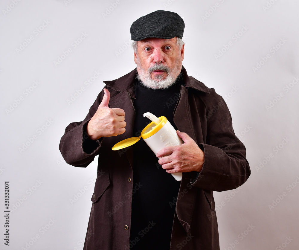 Old man in a trench coat is offering to sell sanitary wipes at exorbitant  prices..Crooked old man profiteering by selling disinfecting wipes on the  black market. Stock Photo | Adobe Stock