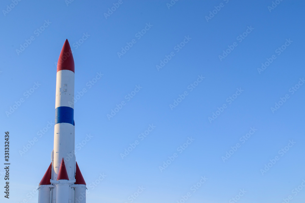 Rocket at the start. Four engines. Colors - red, white, blue. Glare of