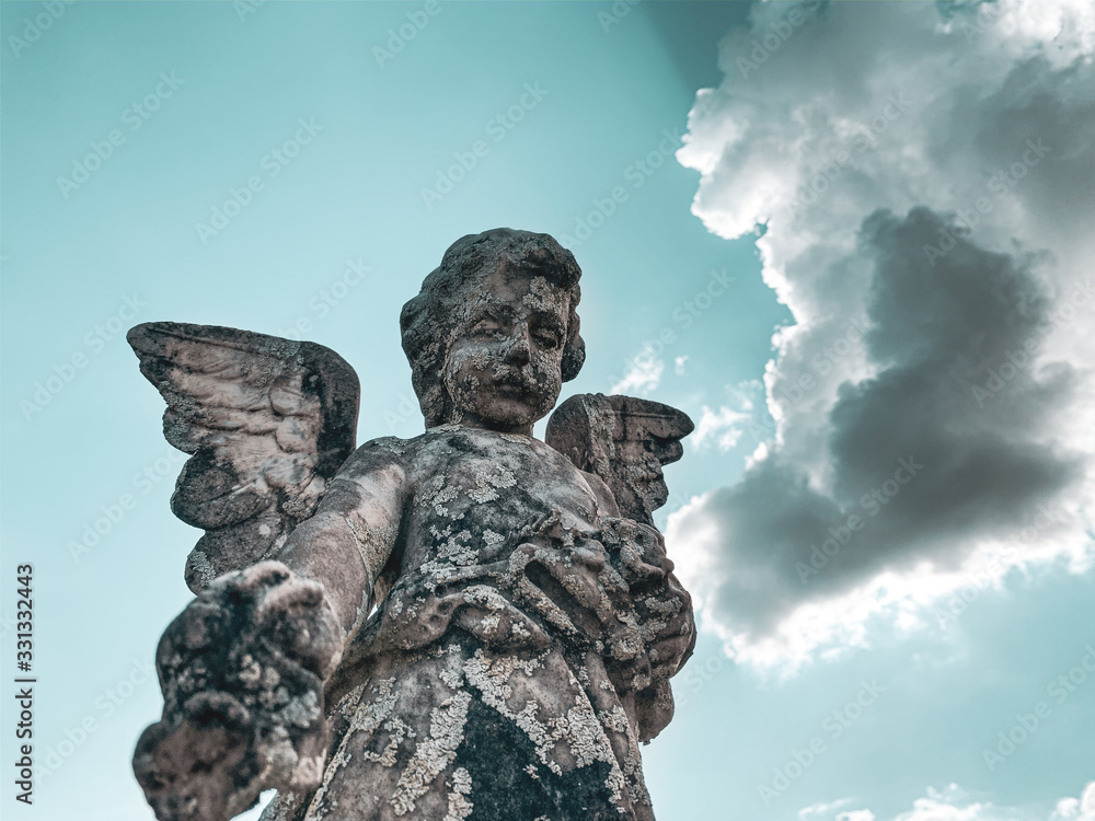 statue of an angel on background of blue sky statue of an angel on background of blue sky