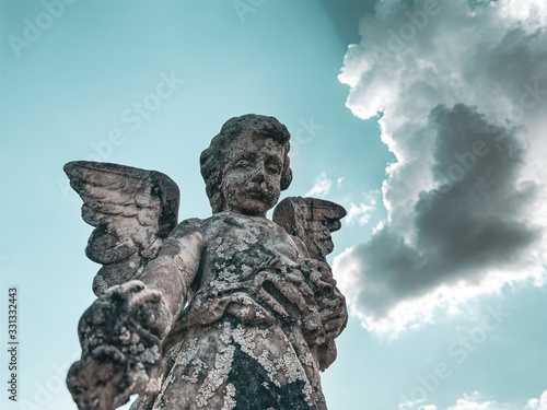 statue of an angel on background of blue sky