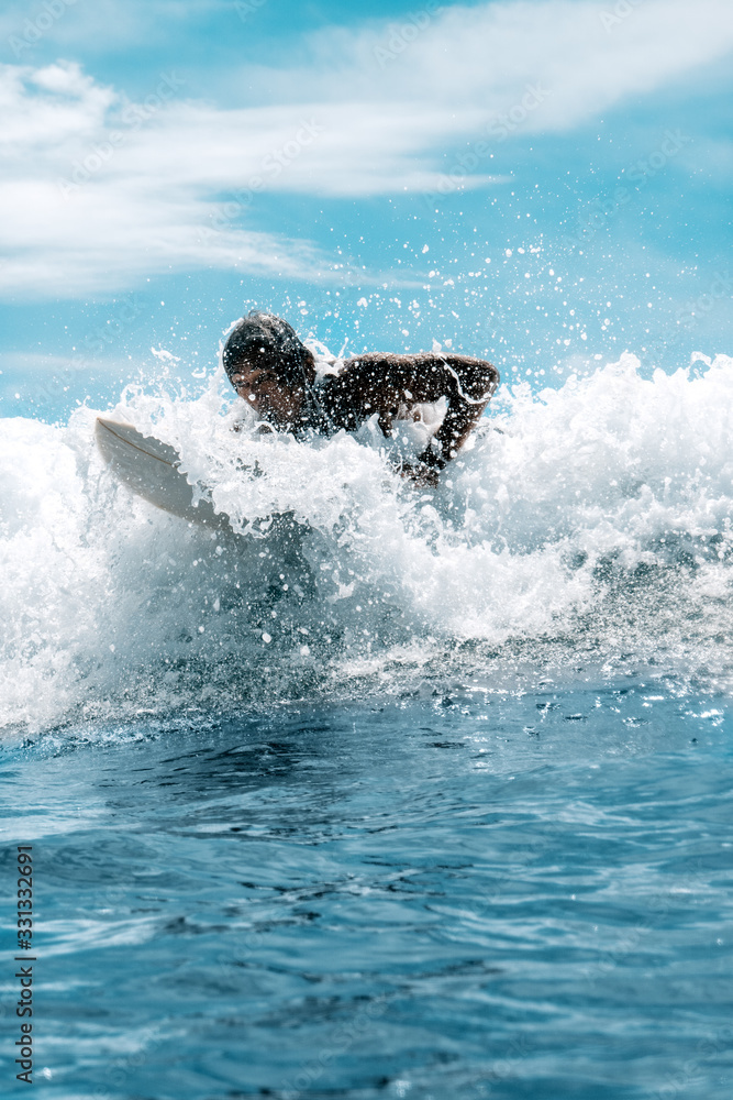 Surfer man in waves inside the ocean with surfboard