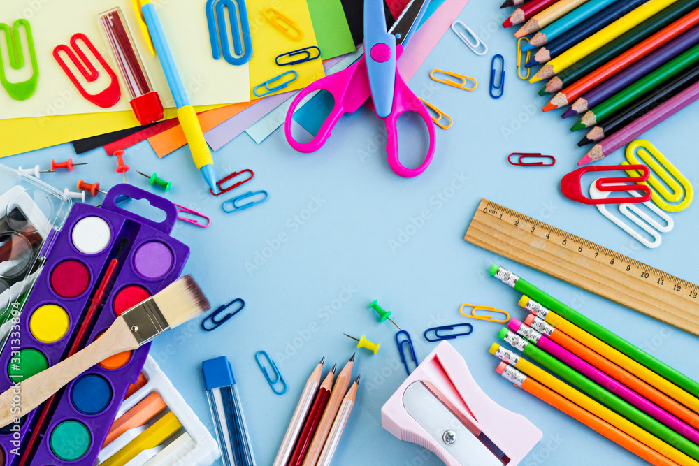 Colorful school supplies on the pastel blue color ground,made a frame ...