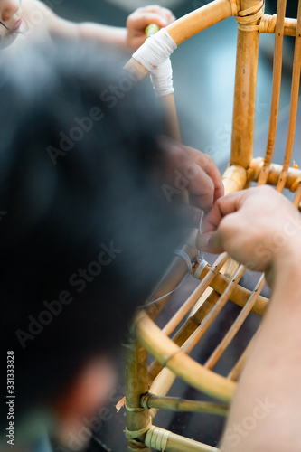 Restoration of rattan chair with white thread. Recycling, upcycling and from trash to reasure concept. Reuse for the environment. photo