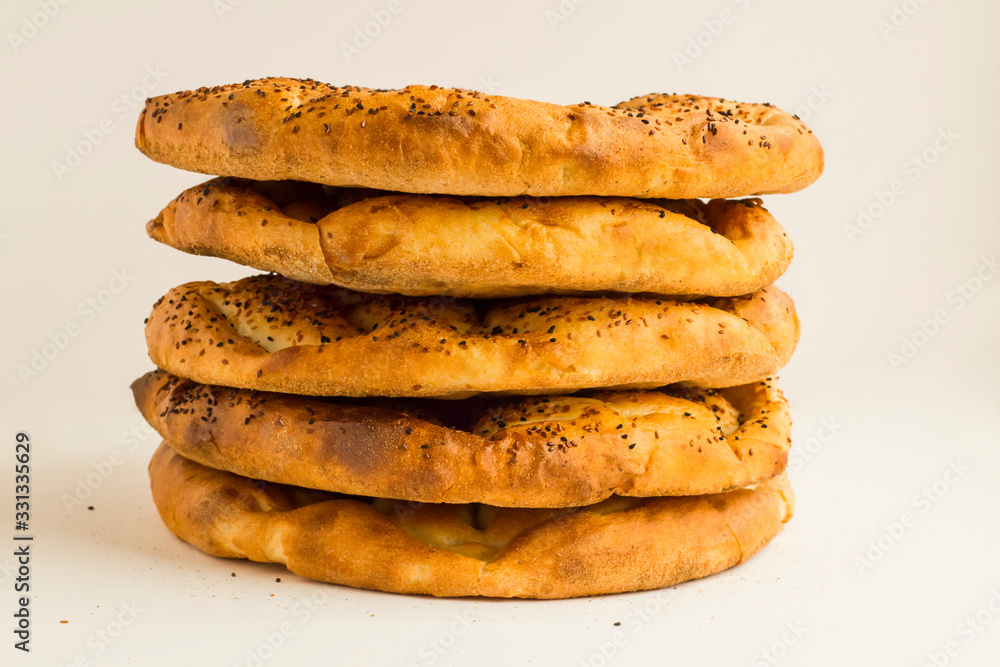 Fresh,Round Ramadan Breads stacked on white with copy space. Fresh,Round Ramadan Breads stacked on white with copy space.