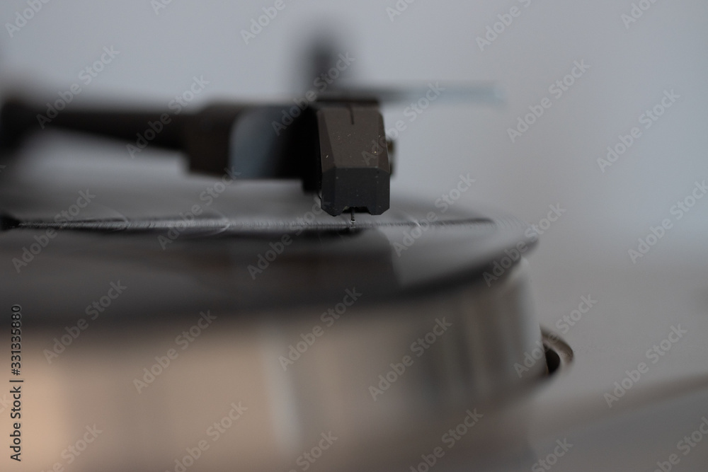 Close up of turntable needle on a vinyl record. Turntable playing vinyl. Needle on rotating black vinyl. Close up of turntable needle on a vinyl record. Turntable playing vinyl. Needle on rotating black vinyl.