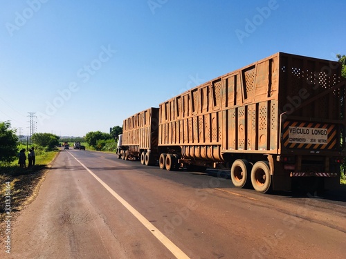 Dourados, Mato Grosso do Sul, Brazil - March 14, 2020. Beautiful day with blue and cloudless sky. Brazilian highways, Anel Viário Norte (ring road north), Brazilian roads, we see trucks at high speed.