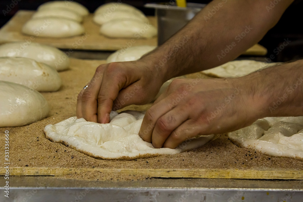 Traditional Turkish Ramadan bread (pide)preparing in the bakehouse.Close up taken