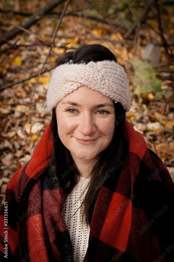 young woman in autumn park with plaid blanket young woman in autumn park with plaid blanket