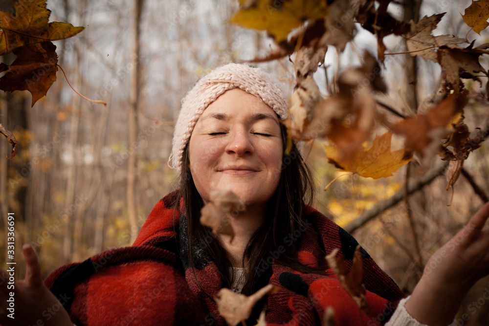young woman in autumn park with plaid blanket young woman in autumn park with plaid blanket