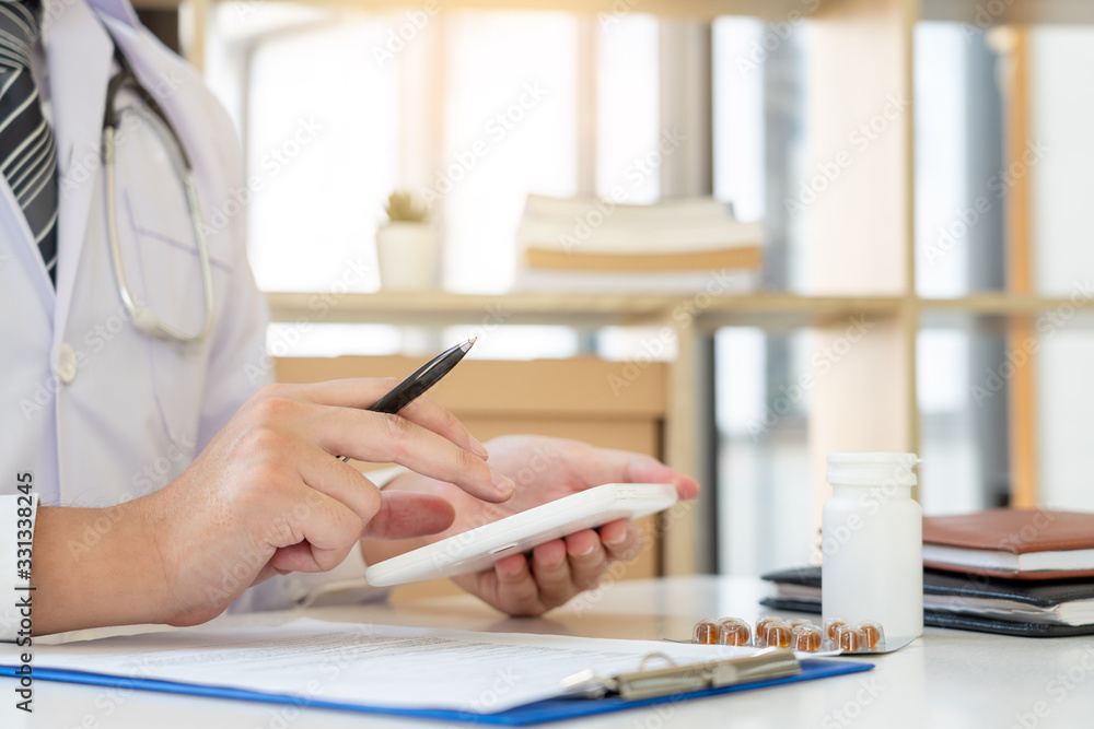 Fototapeta premium Doctor working at office desk with modern medical healthcare concept, Hospital background.
