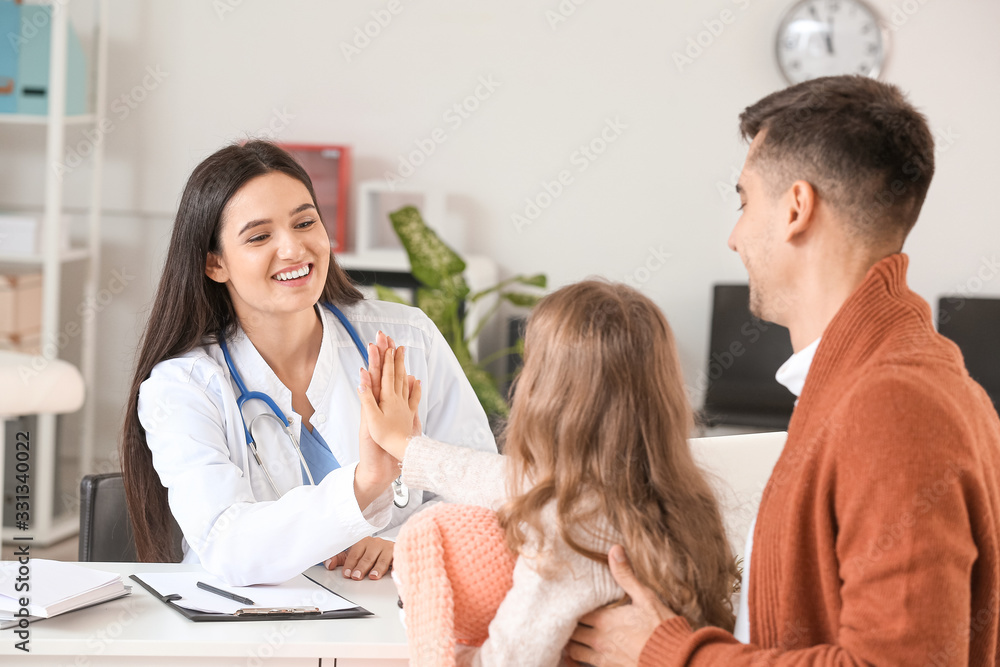 Man with little daughter visiting pediatrician in clinic Man with little daughter visiting pediatrician in clinic