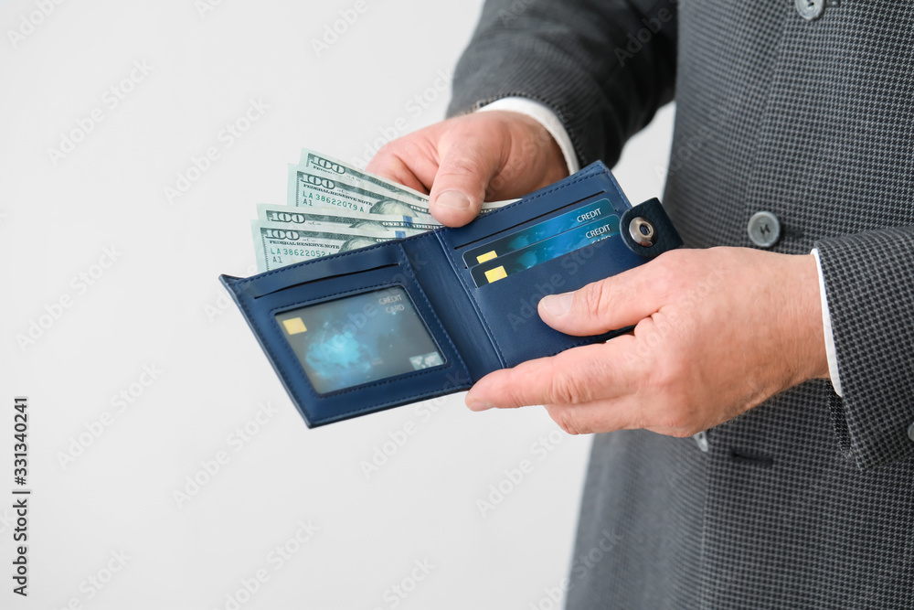 Senior businessman with purse on light background, closeup Senior businessman with purse on light background, closeup
