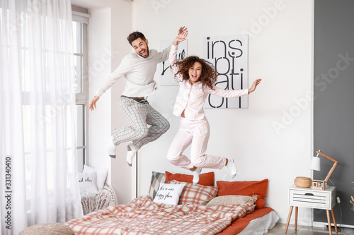 Happy young couple jumping ...