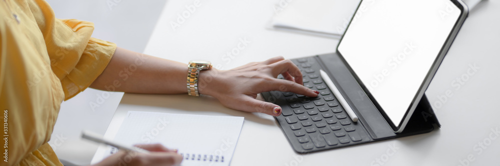 Cropped shot of female entrepreneur focusing on her work with mock-up tablet Cropped shot of female entrepreneur focusing on her work with mock-up tablet