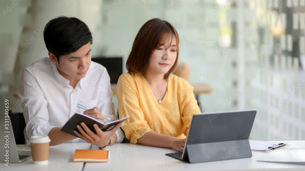 Cropped shot of two businesspeople sitting in glass glass wall office room Cropped shot of two businesspeople sitting in glass glass wall office room