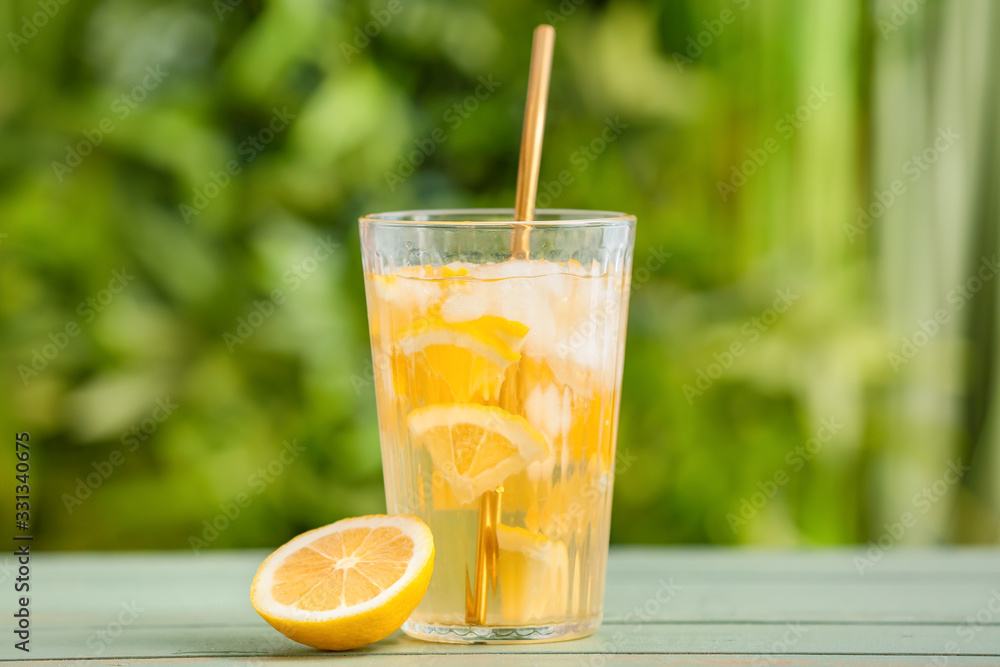 Glass with cold tea on table outdoors Glass with cold tea on table outdoors
