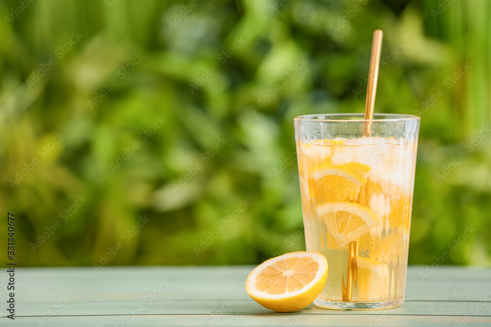 Glass with cold tea on table outdoors Glass with cold tea on table outdoors