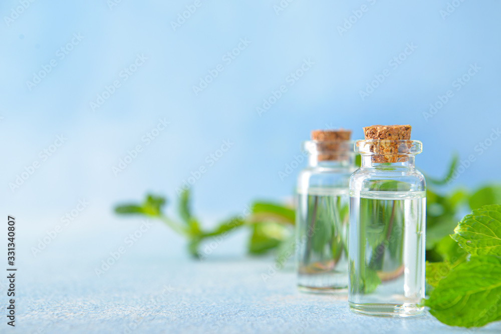 Bottles of mint essential oil on table Bottles of mint essential oil on table