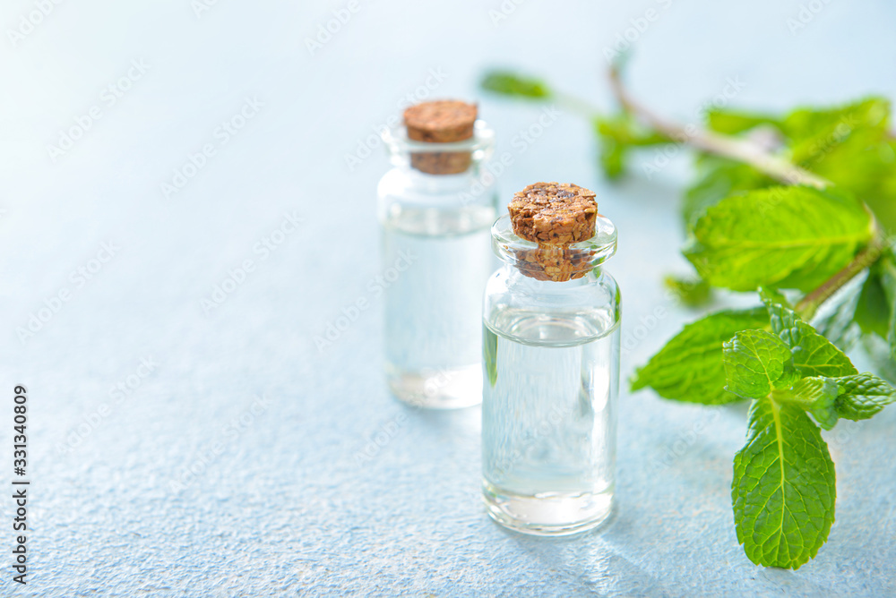 Bottles of mint essential oil on table Bottles of mint essential oil on table