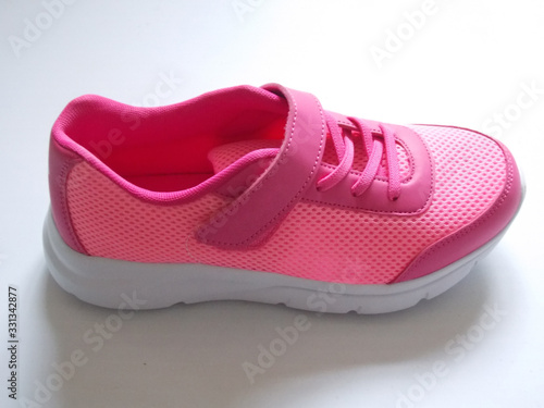 Pink youth sneakers Isolated on a white background.