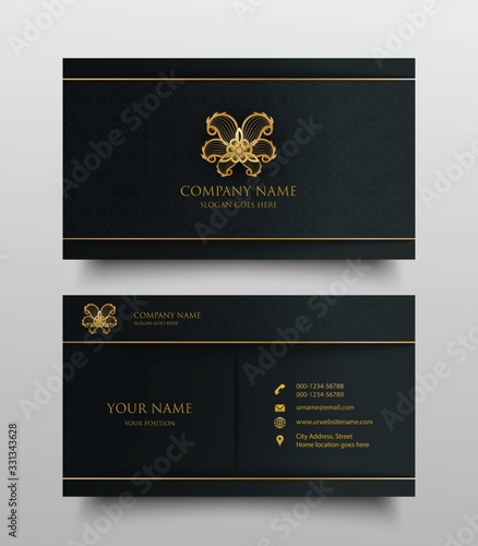 business card with gold floral logo and place for text on dark background