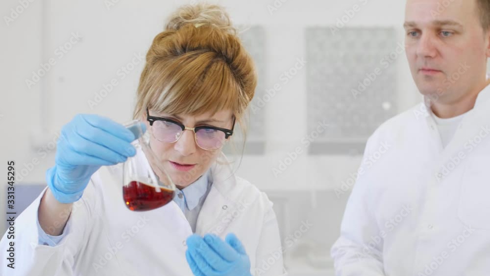 Close up of two scientists working with CBD oil Close up of two scientists working with CBD oil