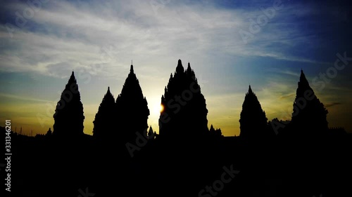 Wide angle shot of Prambanan hindu temple silhouette on a sunset, orange sky, wide angle shot, Java, Yogyakarta, Indonesia