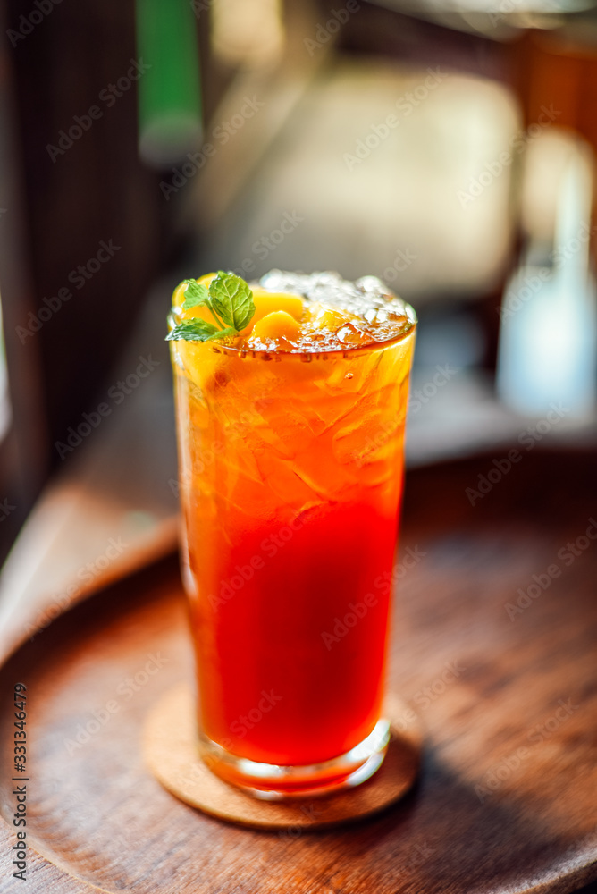 Iced peach tea in a glass on wood table,Fresh Homemade Iced peach tea in a glass on wood table,Fresh Homemade