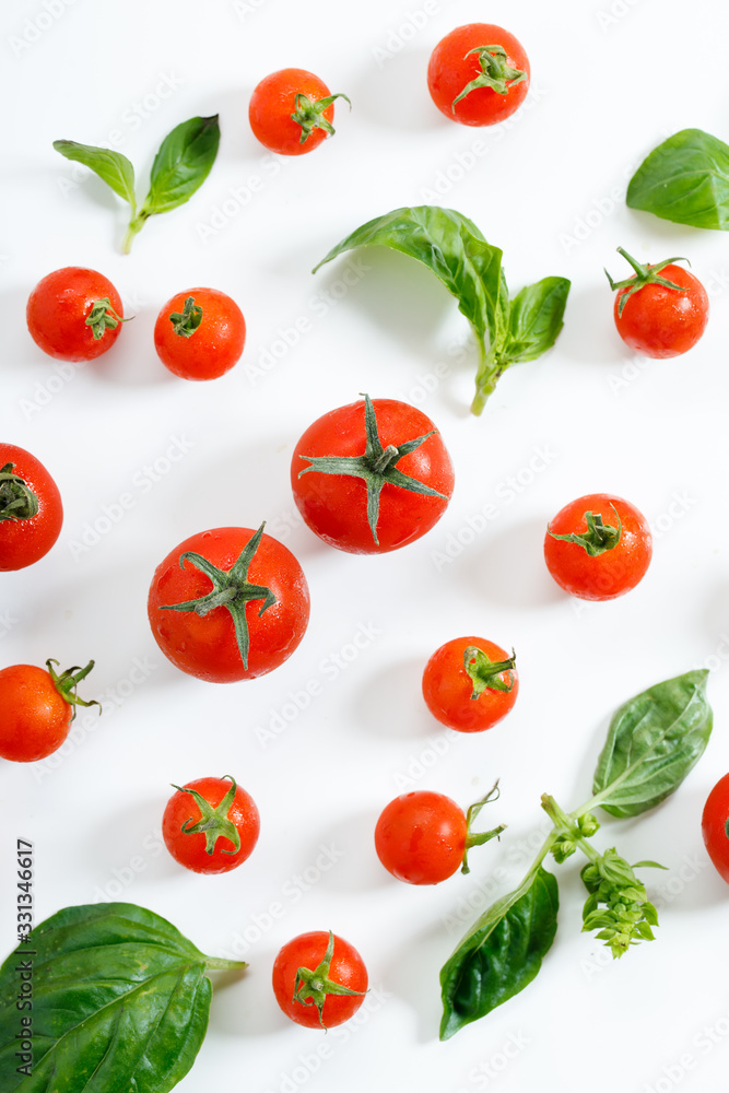 red cherry tomato and basil leaf on white background red cherry tomato and basil leaf on white background