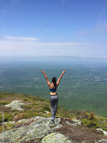 Woman enjoying the beautiful view of hills and mountains whilst hiking in Maine USA