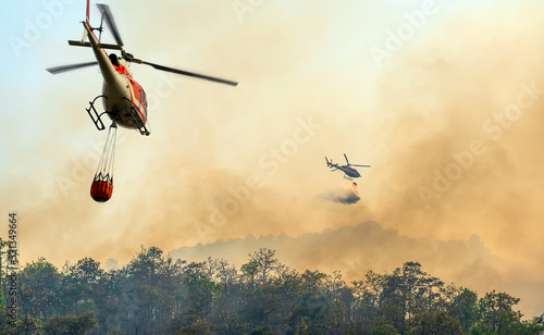 Fototapeta Naklejka Na Ścianę i Meble -  Helicopter dumping water on forest fire