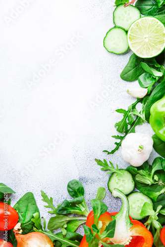Healthy food background with various green herbs and vegetables. Ingredients for cooking salad. Vegetarian and vegan food concept. Top view, copy space