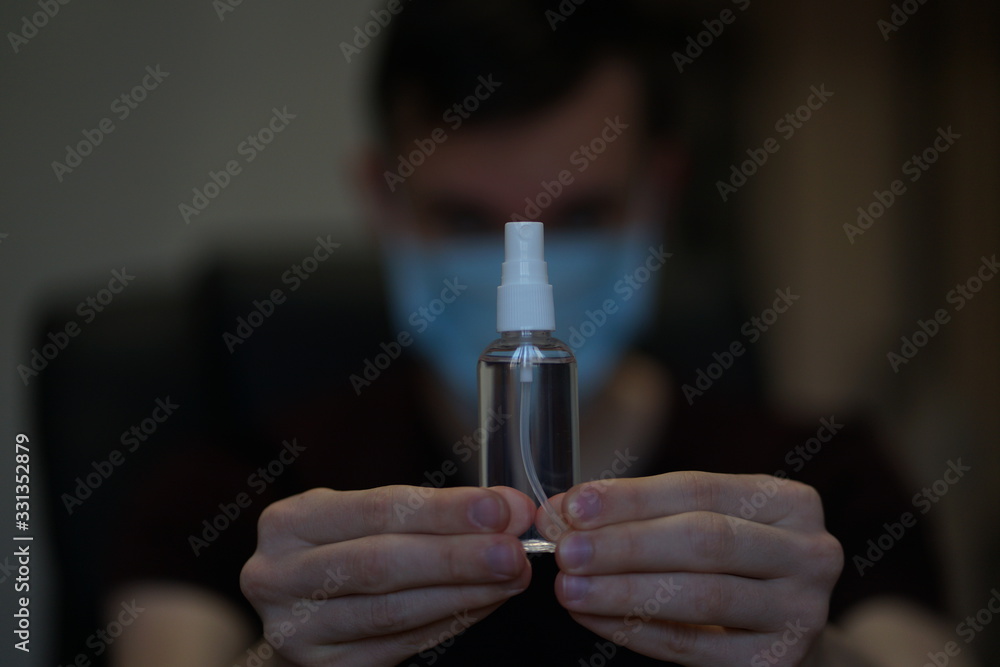 Man in protective mask and with antibacterial antiseptic gel for hands disinfection and health protection prevention during flu virus outbreak, epidemic and infectious diseases Man in protective mask and with antibacterial antiseptic gel for hands disinfection and health protection prevention during flu virus outbreak, epidemic and infectious diseases
