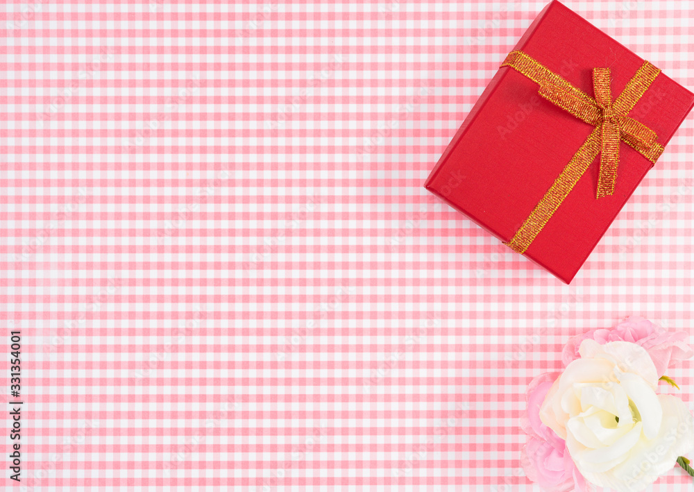 gift box with red isolated on Plaid background. Holiday decoration for Mother's Day or Women's Day. gift box with red isolated on Plaid background. Holiday decoration for Mother's Day or Women's Day.
