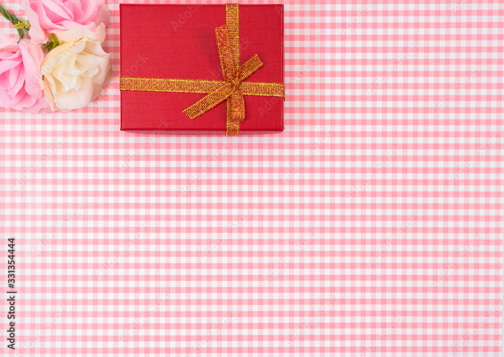 gift box with red isolated on Plaid background. Holiday decoration for Mother's Day or Women's Day. gift box with red isolated on Plaid background. Holiday decoration for Mother's Day or Women's Day.