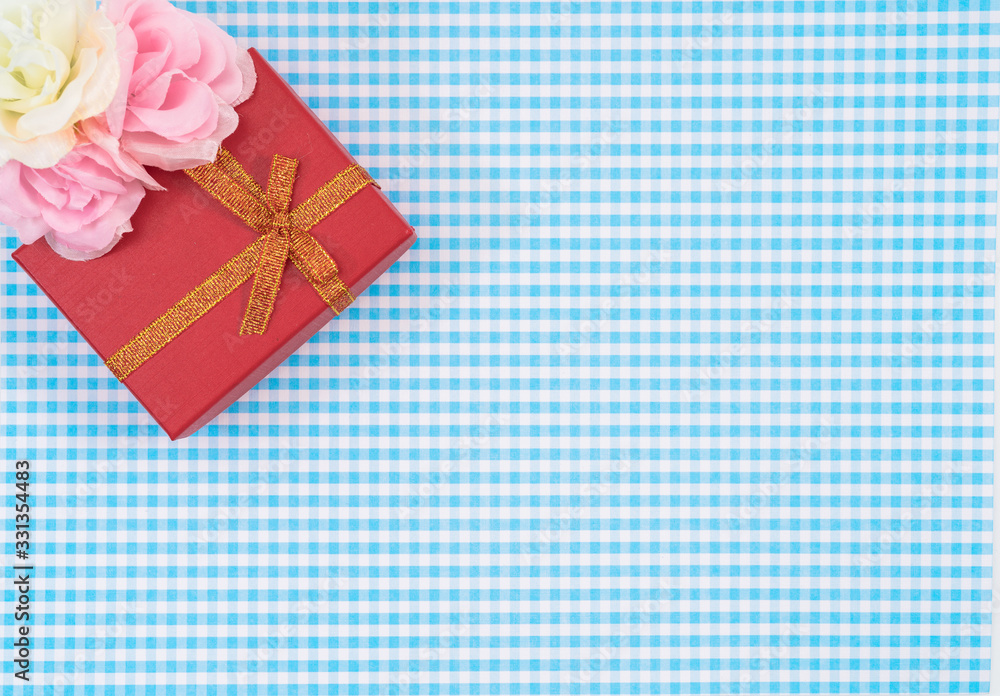gift box with red isolated on Plaid background. Holiday decoration for Mother's Day or Women's Day. gift box with red isolated on Plaid background. Holiday decoration for Mother's Day or Women's Day.