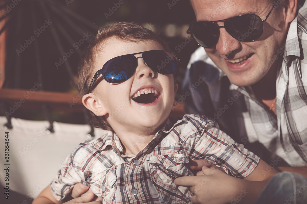 Father and son playing in the park at the day time. Father and son playing in the park at the day time.