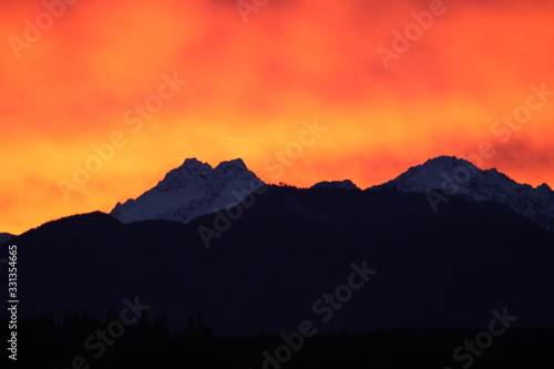 Olympic Mountains with orange burning sky sunset photo