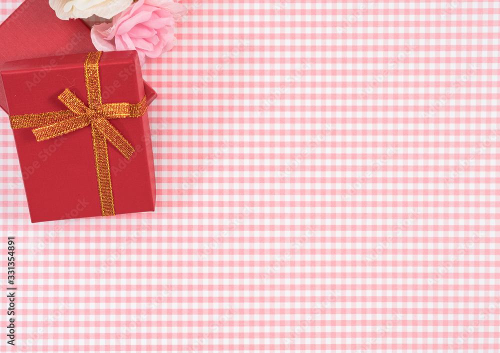 gift box with red isolated on Plaid background. Holiday decoration for Mother's Day or Women's Day. gift box with red isolated on Plaid background. Holiday decoration for Mother's Day or Women's Day.