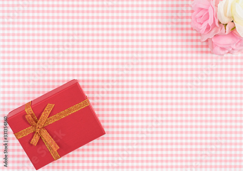 gift box with red isolated on Plaid background. Holiday decoration for Mother's Day or Women's Day.