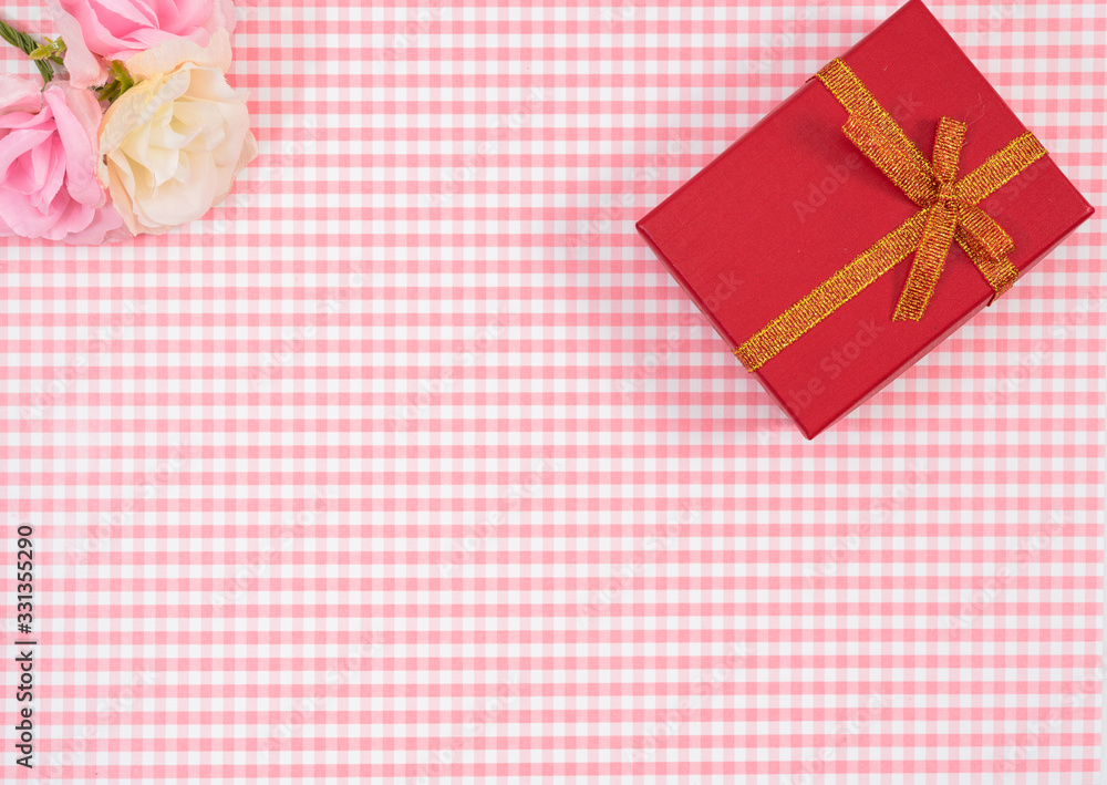 gift box with red isolated on Plaid background. Holiday decoration for Mother's Day or Women's Day. gift box with red isolated on Plaid background. Holiday decoration for Mother's Day or Women's Day.