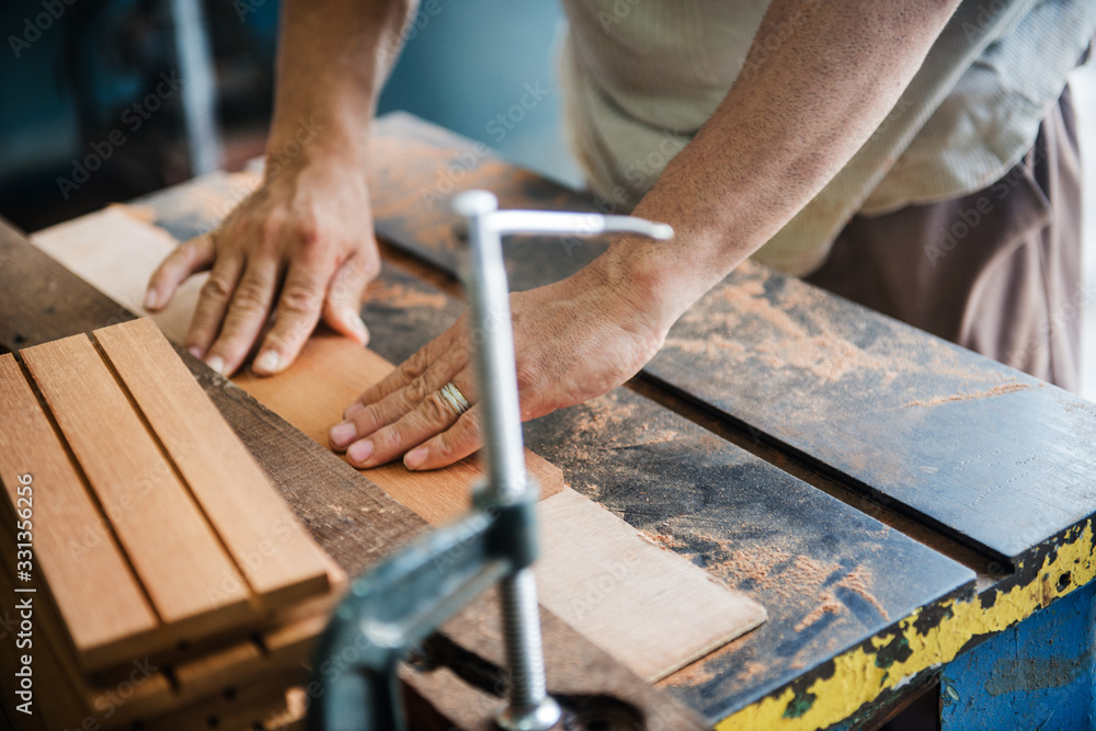 man woodworking in a shop man woodworking in a shop