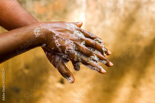 a man washing his hands by soap to maintain hygiene.stay healthy.avoid germ and virus.  photo