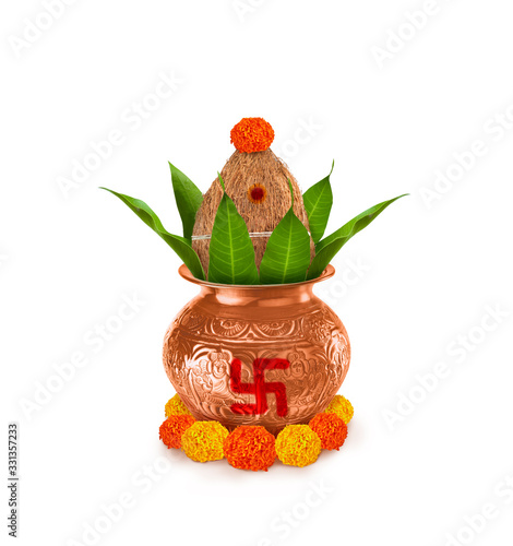 Copper and gold kalash with coconut and mango leaf with marigold flower decoration at the bottom for hindu puja  for all hindu pooja occasions 