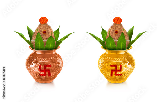 Copper and gold kalash with coconut and mango leaf with marigold flower decoration at the bottom for hindu puja  for all hindu pooja occasions  photo