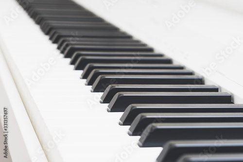 keys on a white piano close -up, tinted image, selective focus