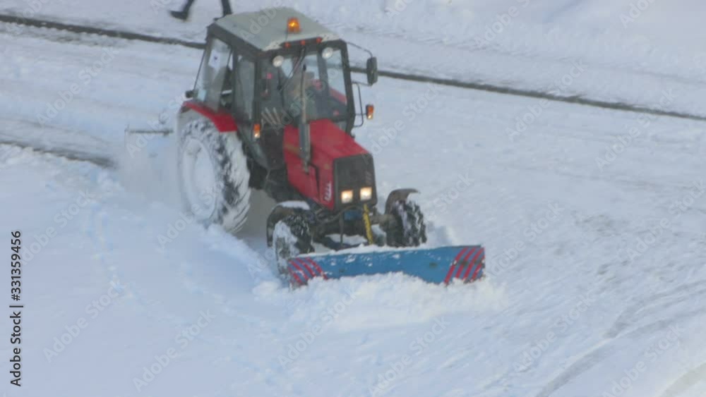 Tractor removing snow from walkways Tractor removing snow from walkways