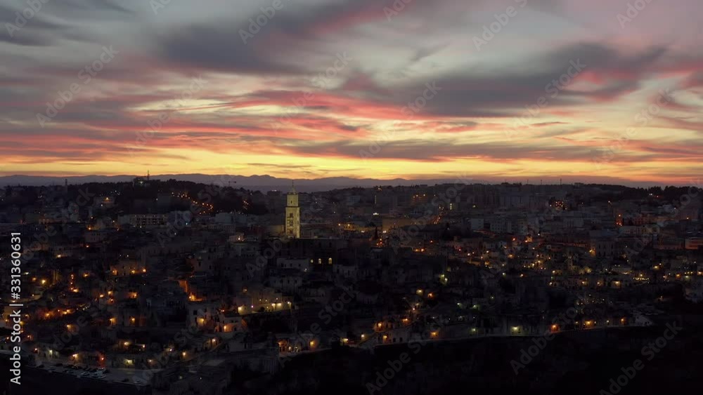 Aerial view of Matera, Basilicata, Italy. Sunset light with violet sky and sun going down on the Sassi of Matera, Unesco heritage Aerial view of Matera, Basilicata, Italy. Sunset light with violet sky and sun going down on the Sassi of Matera, Unesco heritage
