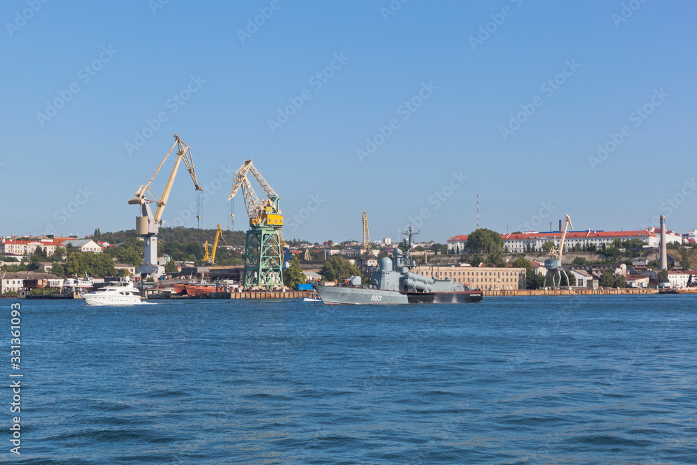R-239 missile boat on the background of tower cranes of the Sevastopol Sea Port, Crimea