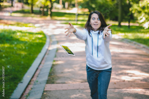 young woman let down mobile phone on stone ground